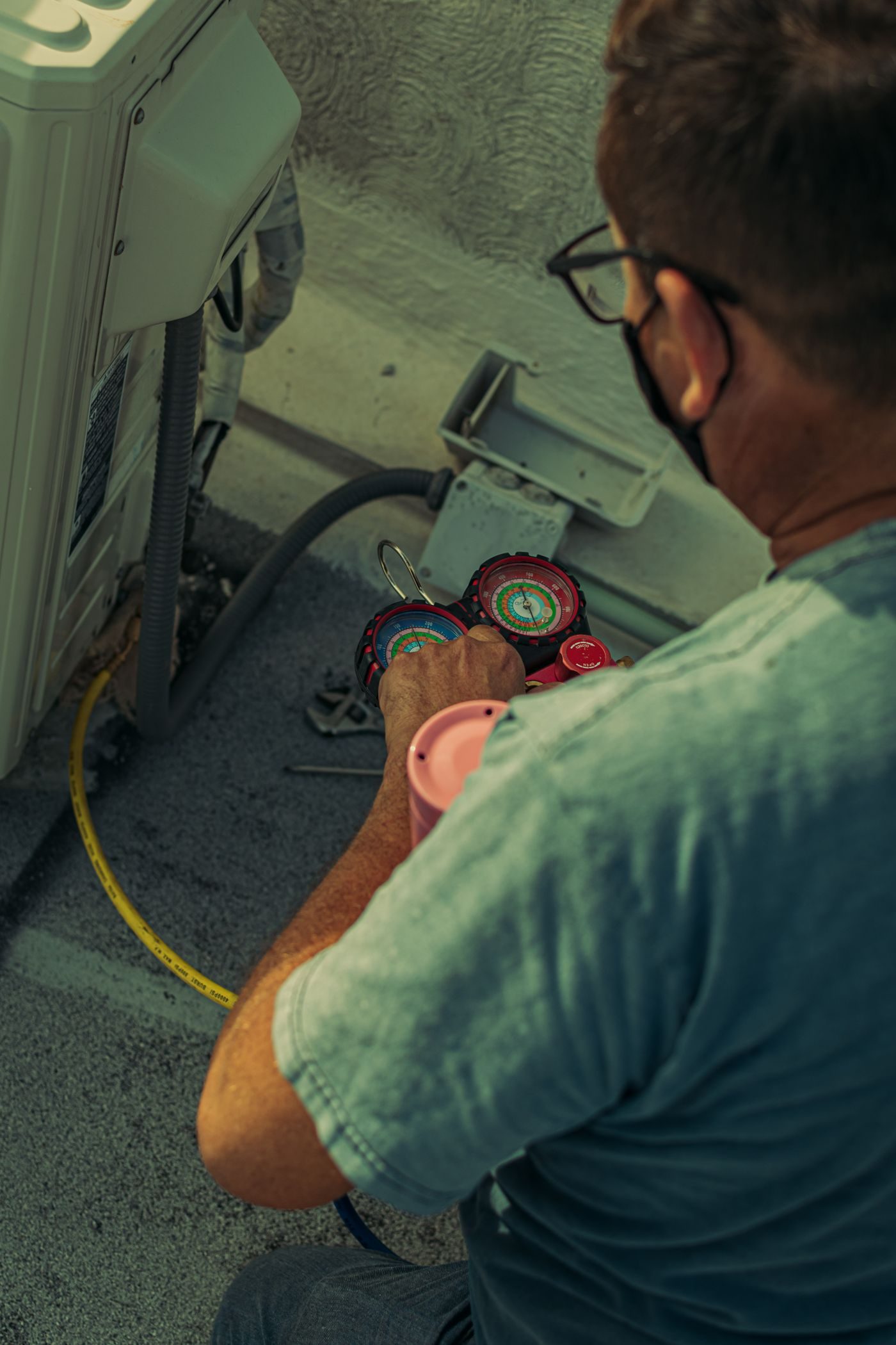 HVAC technician working on an outdoor unit